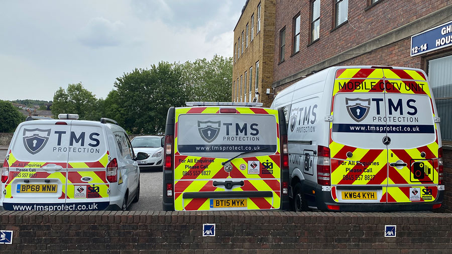 Three parked TMS Vans